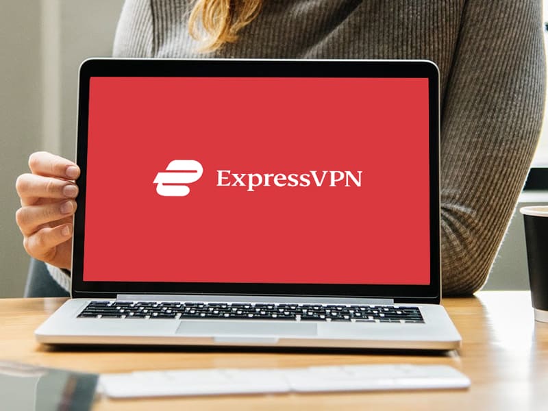 Laptop displaying ExpressVPN logo on red screen