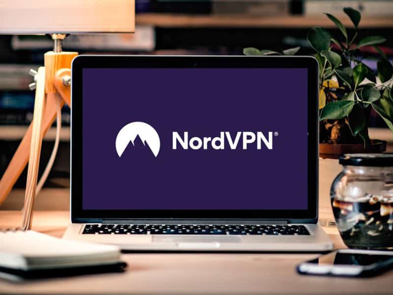 Laptop displaying NordVPN logo on desk
