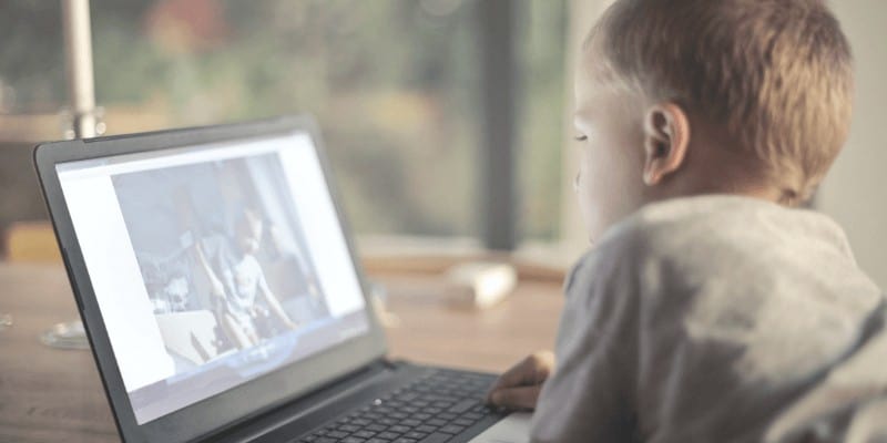 Young child using laptop at home