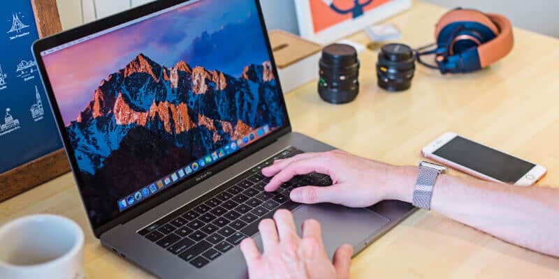 Person typing on laptop at organized desk setup